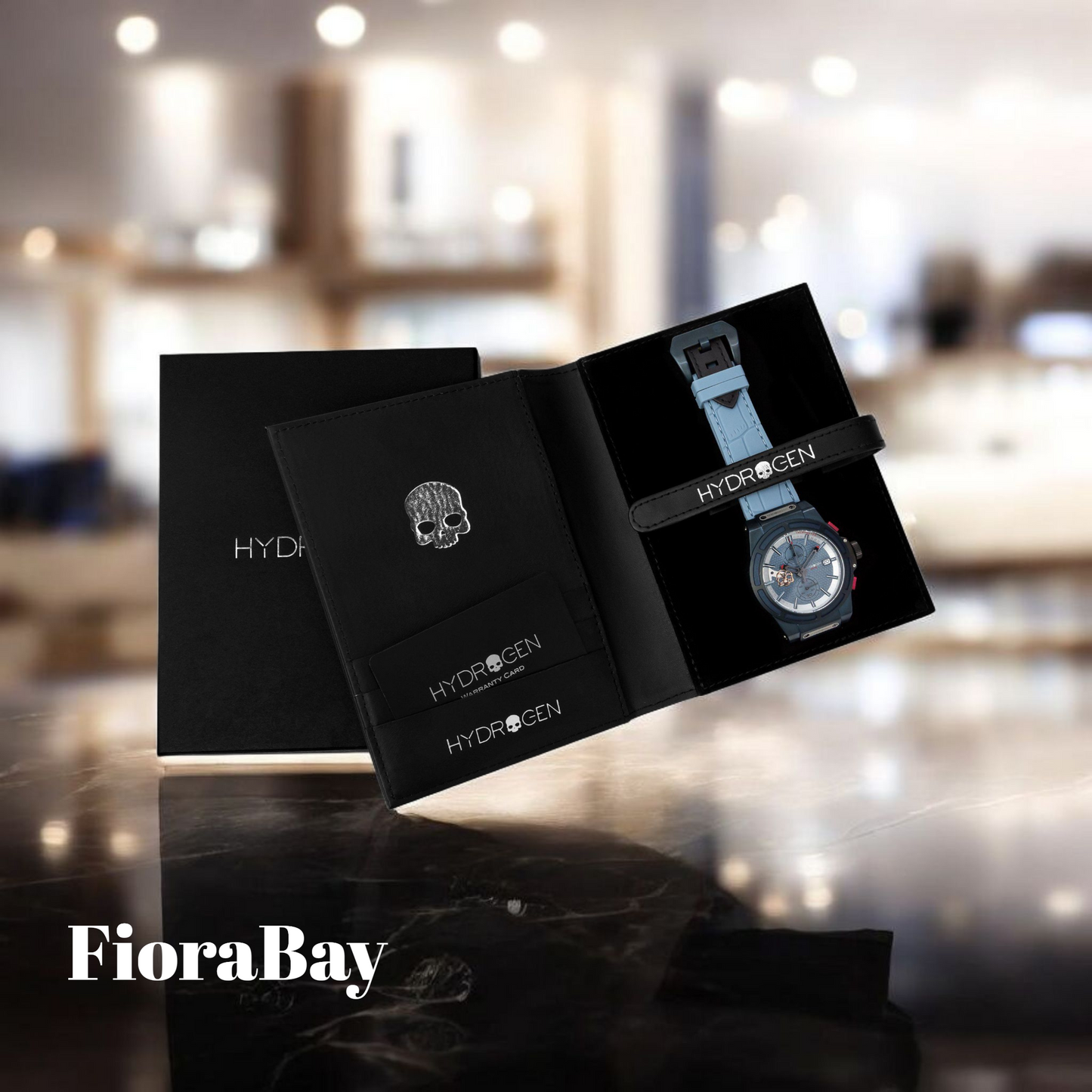 Black Hydrogen watch box with a watch inside on a blurred indoor background